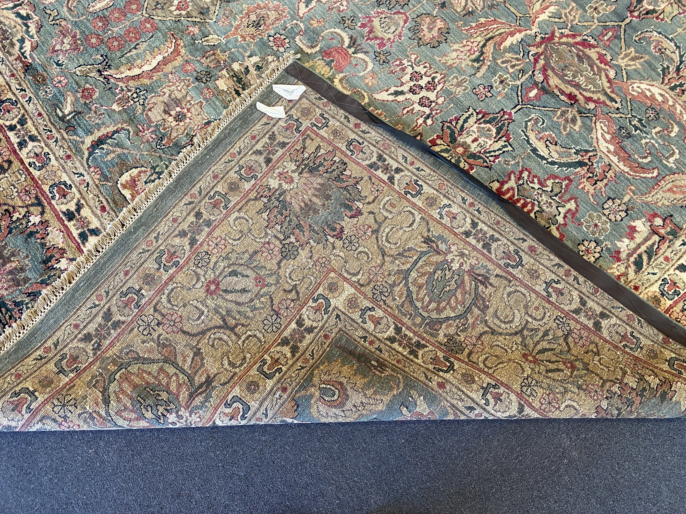 An Indian Persian style sage green ground carpet, 465 x 363cm